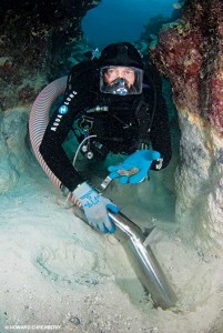 John Chatterton uses a dredge to search for silver coins at a wreck site.